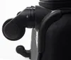 Close-up of the wheels and corner of a black suitcase. Podgląd zdjęcia produktu
