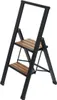 A black and wood-colored step stool is shown against a white background. Podgląd zdjęcia produktu