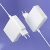 Two white power adapters are shown floating against a light purple background. Podgląd zdjęcia produktu