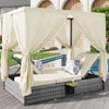 A canopy daybed with cushions and a small table is set up on a wooden deck next to a swimming pool. Anteprima dell’immagine prodotto