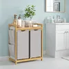 A bathroom scene with a laundry cart and vanity. Produktbild-Vorschau