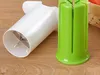 A white and green vegetable cutter on a wooden surface. Podgląd zdjęcia produktu