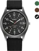 A close-up studio shot of a black men's wristwatch with a black fabric strap. Produktbild-Vorschau