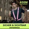 A man is running at night in a city street, wearing a reflective vest. Náhľad obrázku produktu