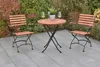 A garden table and chairs set on a patio. Produktbild-Vorschau