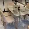 A dining table with chairs in a modern setting. Produktbild-Vorschau