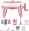 A pink and white knitting machine with various accessories laid out below it on a white background. Náhled obrázku produktu