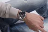 A person wearing a watch and jeans. Náhled obrázku produktu