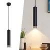 A collage showing a black pendant light on a white background on the left, and the same light hanging over a table with a vase and glasses on the right. Anteprima dell’immagine prodotto