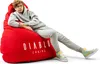A young person is sitting on a large red beanbag chair. Náhled obrázku produktu