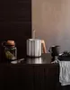 A kitchen counter with a tea pot, a jar, and a mug. Náhled obrázku produktu