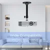 A projector mounted on a ceiling bracket in a room with a sofa. Náhled obrázku produktu