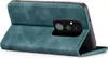 A teal flip case for a smartphone is shown from the back, with the camera module exposed. Produktbild-Vorschau