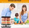 A family is preparing food in a kitchen, with a food dehydrator prominently displayed. Voir les images du produit