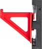A red plastic bracket is attached to a black modular storage system. Podgląd zdjęcia produktu