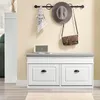 A hallway or entryway scene with a shoe bench, coat rack, and accessories. Produktbild-Vorschau