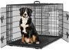 A Bernese Mountain Dog sits inside a black metal dog crate with its doors open. Produktbild-Vorschau