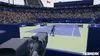 A tennis match is being played on a blue court in a stadium with spectators. Produktbild-Vorschau