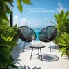 Two black chairs and a small table are set up on a patio overlooking a tropical ocean view. Náhled obrázku produktu
