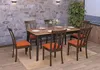 A dining set with chairs and a table in a room with a stone wall background. Voir les images du produit