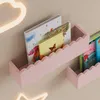 Two pink cloud-shaped shelves mounted on a wall, holding children's books. Produktbild-Vorschau