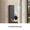 A child reaching for a tall, dark grey electric heater with a blue shield and lock icon overlay. Anteprima dell’immagine prodotto