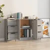 A gray wooden sideboard with drawers and doors, filled with books and decorative items, placed against a white wall. Produktbild-Vorschau
