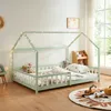A child's bed with a house frame, decorated with fairy lights, in a bedroom setting. Produktbild-Vorschau