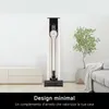 A modern living room with a vacuum cleaner on a stand next to a plant and a sofa. Náhled obrázku produktu