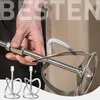 A hand holding a mixer attachment for a power tool, with two smaller attachments in the foreground. Náhled obrázku produktu