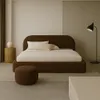 A minimalist bedroom scene featuring a large bed. Anteprima dell’immagine prodotto