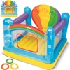 An inflatable play structure with a rainbow theme, shown from a slightly elevated diagonal angle against a white background. Three small rings are placed in the foreground. Voir les images du produit