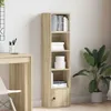 A tall, narrow bookshelf with a wood grain finish, placed next to a desk and a potted plant. Náhled obrázku produktu