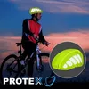 A cyclist wearing a helmet cover with reflective details on a bicycle against a twilight sky. Produktbild-Vorschau