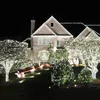 A house decorated with numerous white LED Christmas lights at night, with a Santa and sleigh decoration in the yard. Náhled obrázku produktu