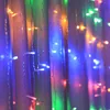 A close-up view of colorful LED string lights draped over fabric. Anteprima dell’immagine prodotto