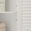 A close-up view of the interior of a white cabinet, showing a shelf and part of a louvered door. Produktbild-Vorschau