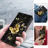 A collage of images showing a black phone case with gold butterflies, one image shows it in a pocket, and another shows a person holding it. Produktbild-Vorschau