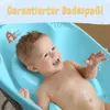 A baby is happily lying in a blue baby bathtub. Produktbild-Vorschau