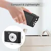 A hand holding a compact digital camera over an open bag. Náhled obrázku produktu