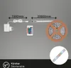 An LED strip light kit with a power adapter, remote control, and the LED strip on a spool, with dimensions indicated. Produktbild-Vorschau