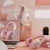 A desk setup with headphones, a laptop, books, and a cactus. Voir les images du produit