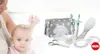 A mother is brushing her baby's hair, with a NUK baby starter set laid out next to them. Produktbild-Vorschau
