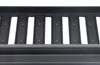 A close-up view of a black metal grate with vertical slots and small raised dots. Produktbild-Vorschau