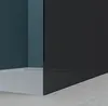 A corner of a modern bathroom with a white bathtub and a dark glass shower wall. Produktbild-Vorschau