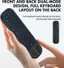 A hand holding a black remote control with a keyboard on the back, with a smaller remote control shown in the background. Produktbild-Vorschau