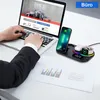 A person using a laptop next to a wireless charging station with a phone, earbuds, and a smartwatch. Produktbild-Vorschau
