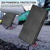 A black phone case is shown in a close-up, with a background of cracked asphalt and a green industrial vehicle. Produktbild-Vorschau