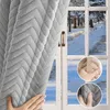 A hand is shown pulling back a gray, textured curtain to reveal a snowy outdoor scene through a window. Anteprima dell’immagine prodotto