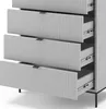 A close-up view of a gray dresser with four drawers, three of which are partially open, showcasing the interior and drawer slides. The dresser has a ribbed texture on the drawer fronts and sleek, dark handles. It sits on thin black legs. Podgląd zdjęcia produktu